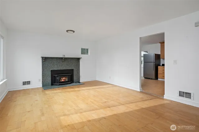 a view of an empty room with a fireplace