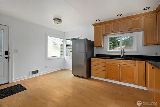 a kitchen with a refrigerator and a sink