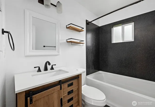 a bathroom with a sink a toilet and a bathtub