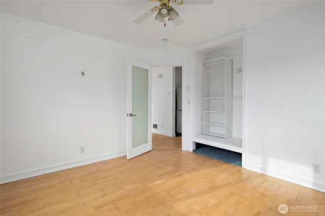 a view of an empty room with a ceiling fan