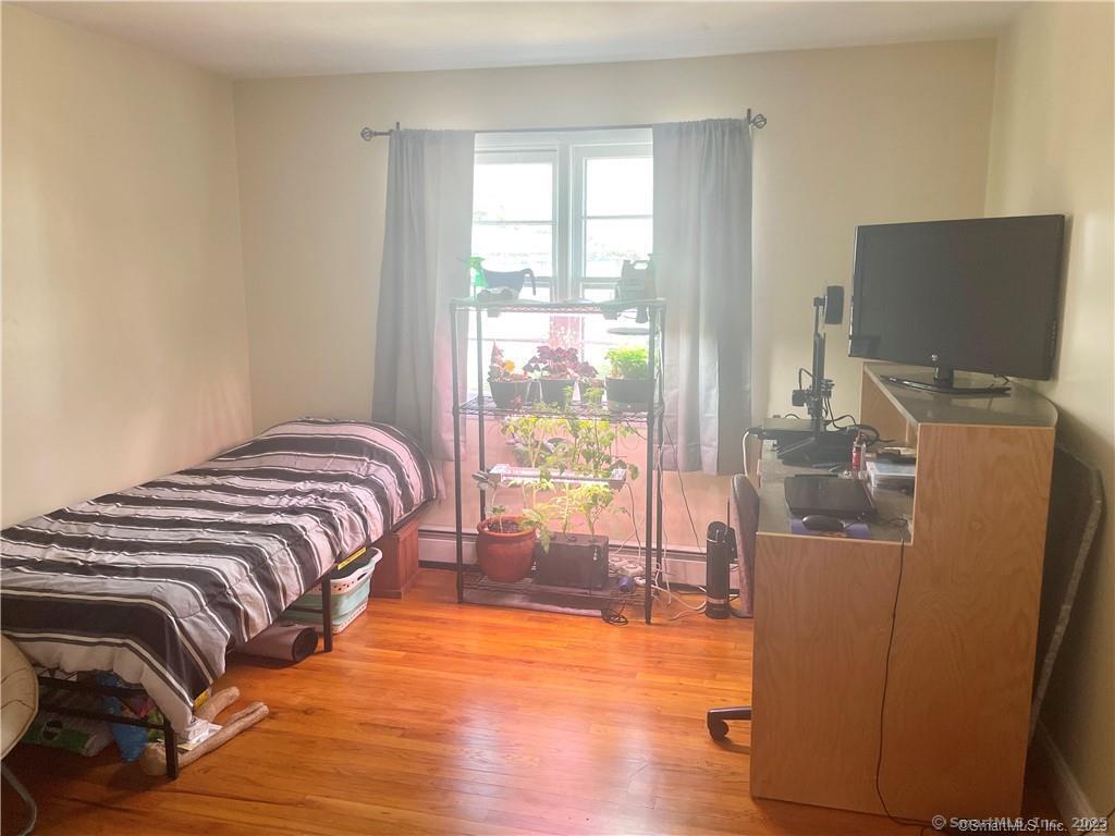 55 Oak Ridge Drive, Unit 60 New Haven, CT 06513 - Photo 13 of 16 a bedroom with a bed and wooden floor
