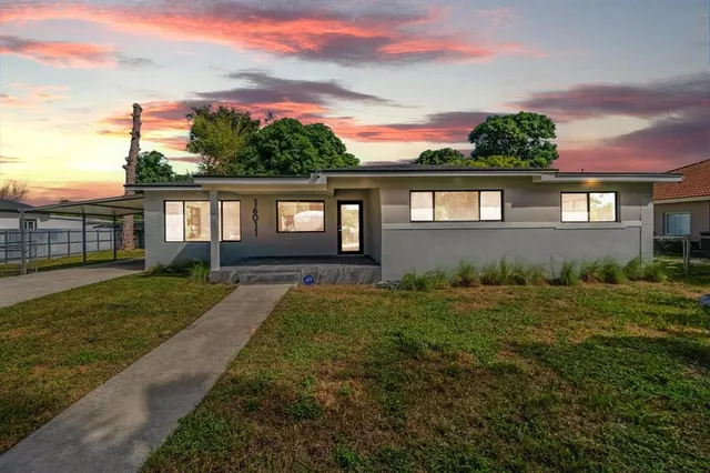 a view of a house with a garden and plants