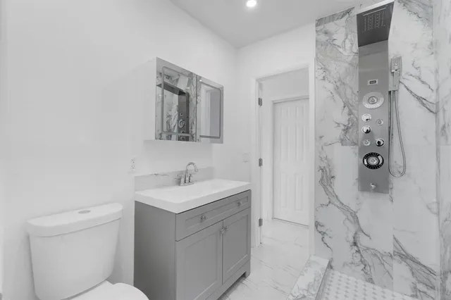 an empty room with windows and cabinet