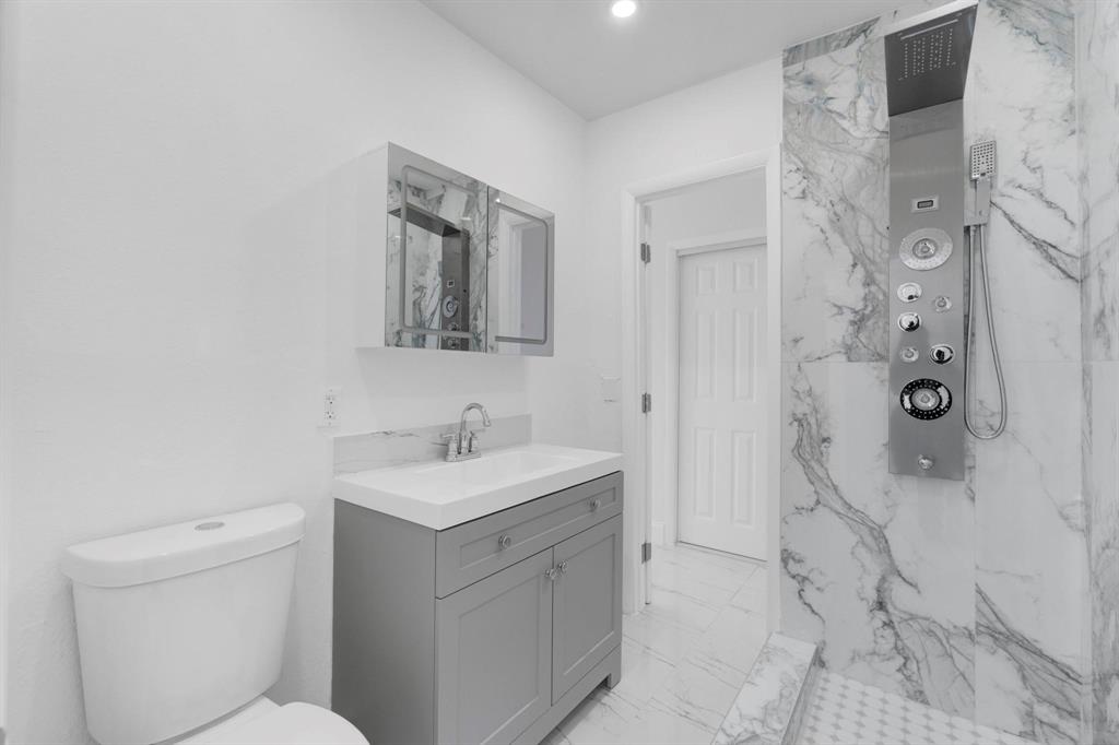 16011 Northwest 38th Court Opa-Locka, FL 33054 - Photo 13 of 38 a bathroom with a sink toilet and shower