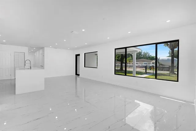 a view of a big room with windows and cabinet