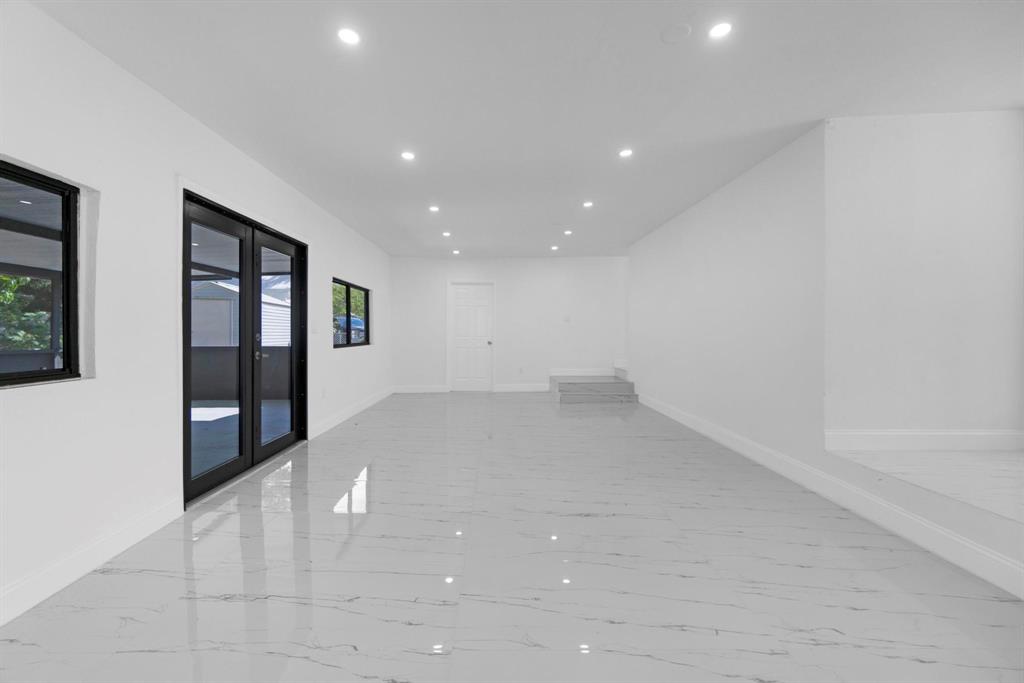 16011 Northwest 38th Court Opa-Locka, FL 33054 - Photo 20 of 38 wooden floor in an empty room with a window