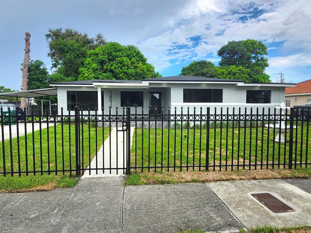 16011 Northwest 38th Court Opa-Locka, FL 33054 - Photo 2 of 38 a view of a house with a garden and plants