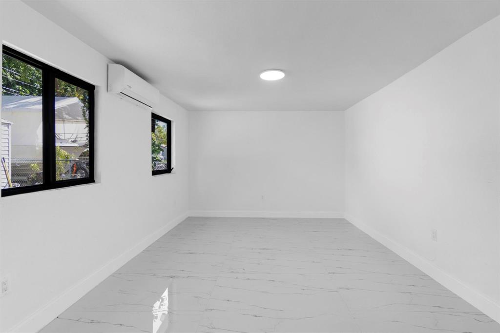 16011 Northwest 38th Court Opa-Locka, FL 33054 - Photo 26 of 38 an empty room with windows