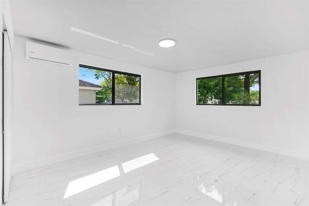 16011 Northwest 38th Court Opa-Locka, FL 33054 - Photo 29 of 38 an empty room with windows