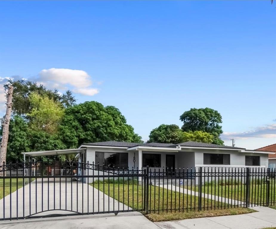 16011 Northwest 38th Court Opa-Locka, FL 33054 - Photo 35 of 38 a front view of a house with a garden
