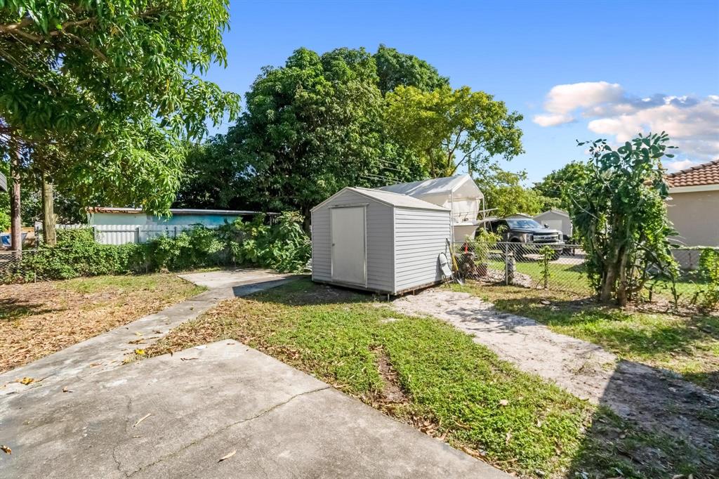 16011 Northwest 38th Court Opa-Locka, FL 33054 - Photo 38 of 38 a backyard of a house with lots of green space