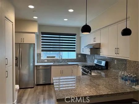 a kitchen with kitchen island a counter top space appliances and cabinets