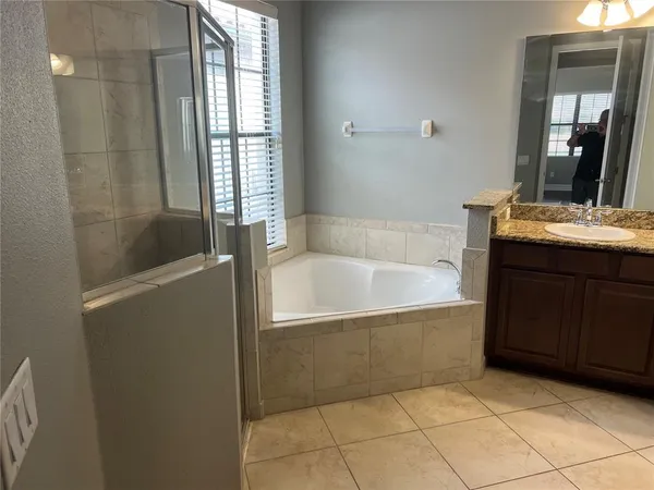 a bathroom with a bathtub and a sink