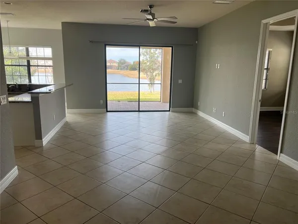 an empty room with a fireplace and windows