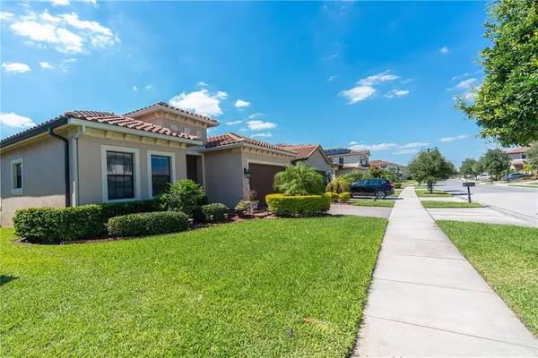 a view of house with yard and green space