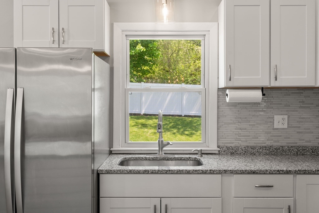 6 Rosenfeld Road Millis, MA 02054 - Photo 4 of 23 a kitchen with a window sink and cabinets