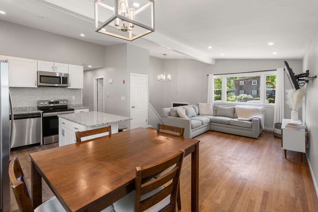 6 Rosenfeld Road Millis, MA 02054 - Photo 6 of 23 a living room with stainless steel appliances furniture a rug and a view of kitchen