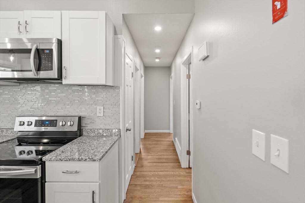 6 Rosenfeld Road Millis, MA 02054 - Photo 8 of 23 a kitchen with stainless steel appliances granite countertop a stove and a microwave