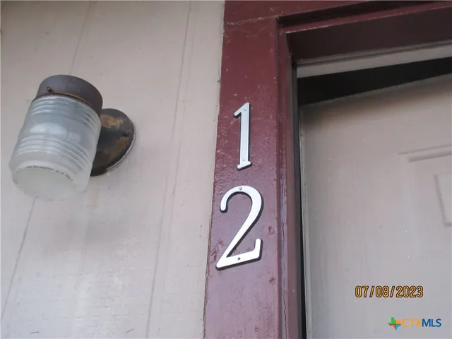 an empty room with closet and fan