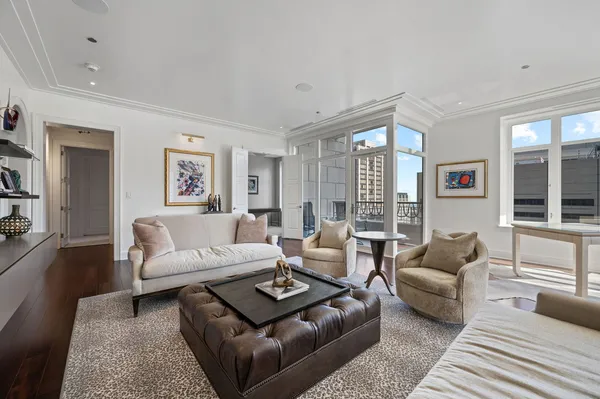 a dining room with furniture a chandelier and window