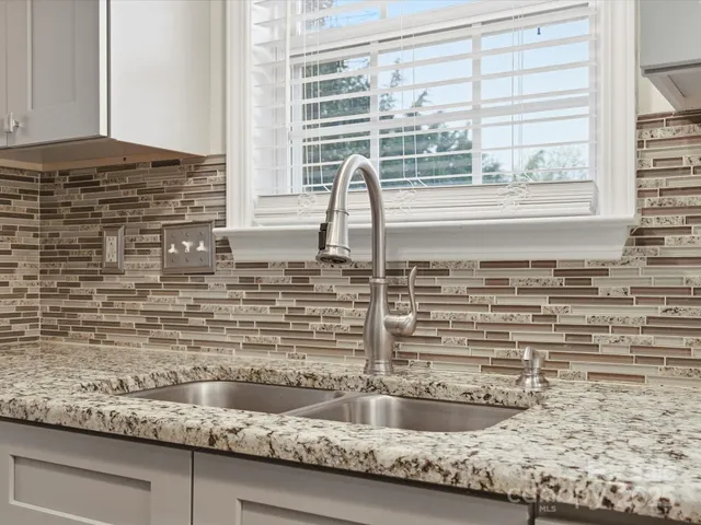 a kitchen with a sink and a window