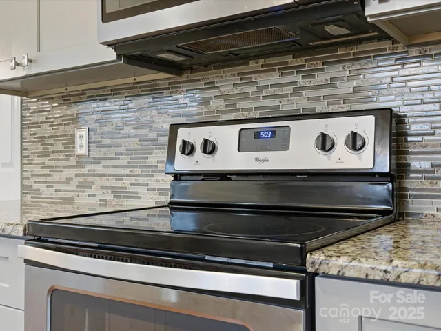 a stove top oven sitting inside of a kitchen
