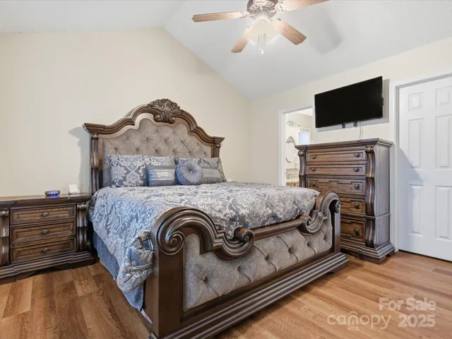 a bedroom with a bed and flat screen tv