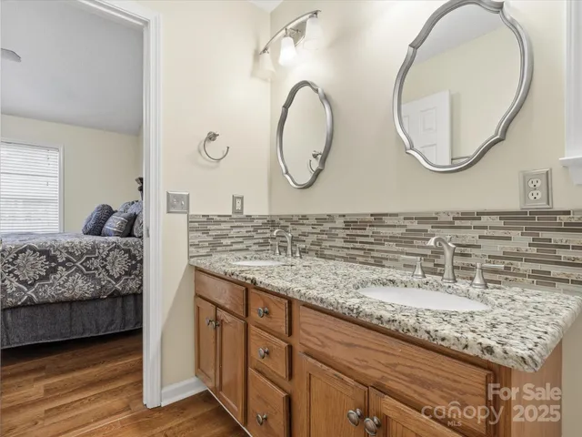a en suite bathroom with a granite countertop and a sink