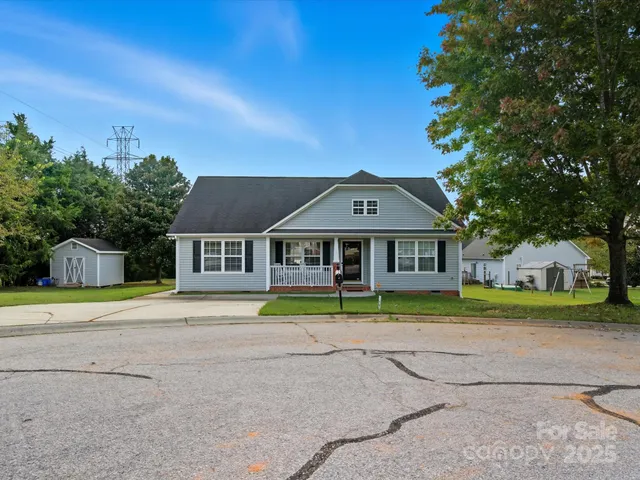 a house that has a big yard and large trees