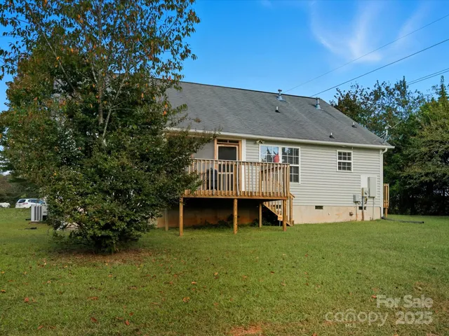 a view of a house with a yard and sitting area