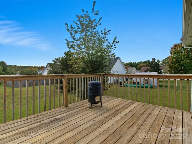 a view of a balcony with wooden floor and fence