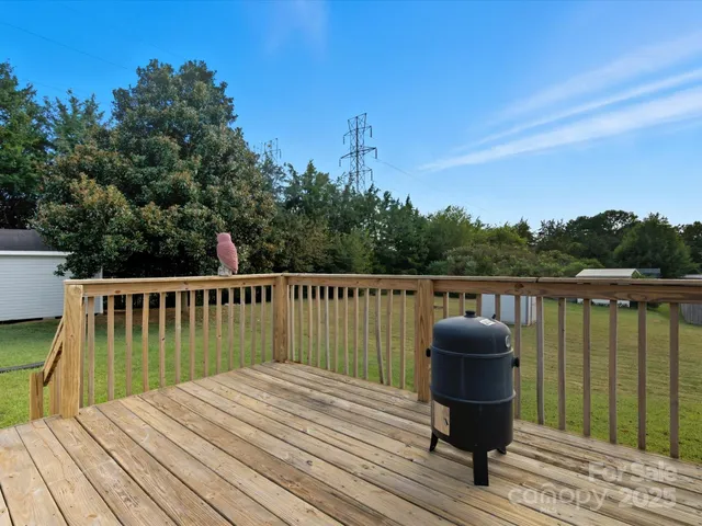 a view of balcony with wooden floor and seating space