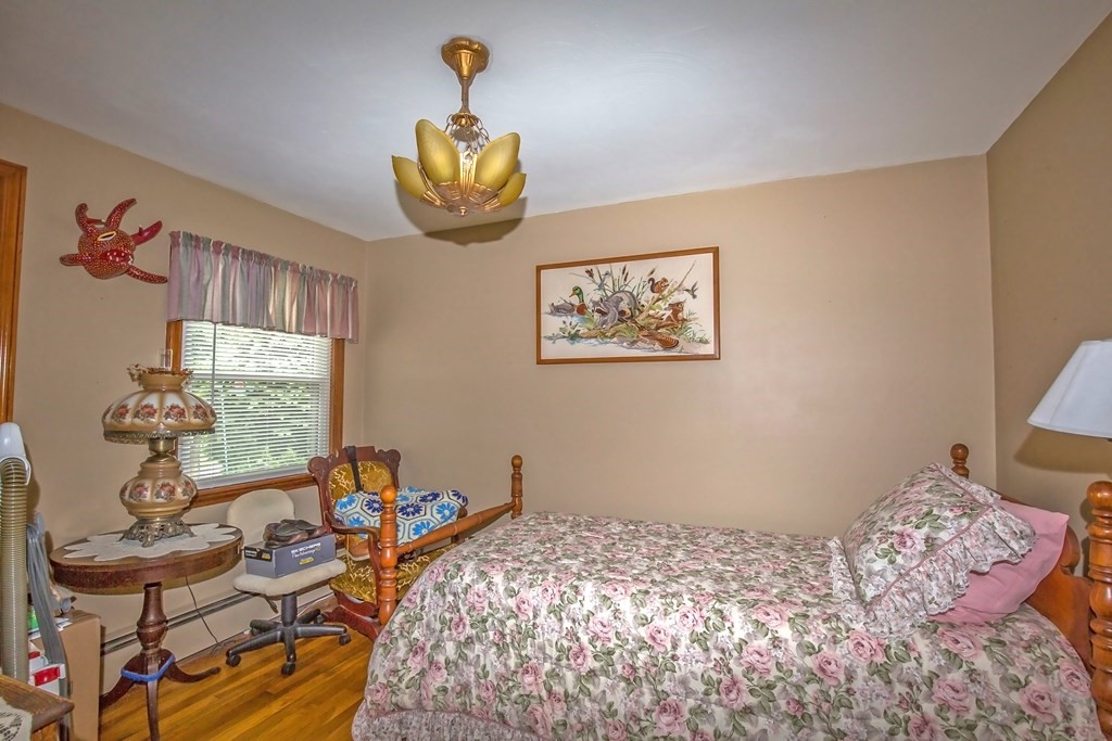 165 Bacon Road Springfield, MA 01119 - Photo 15 of 40 a bedroom with a bed and a chandelier