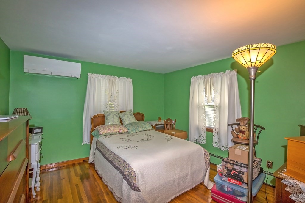 165 Bacon Road Springfield, MA 01119 - Photo 18 of 40 a bedroom with a bed and a chandelier