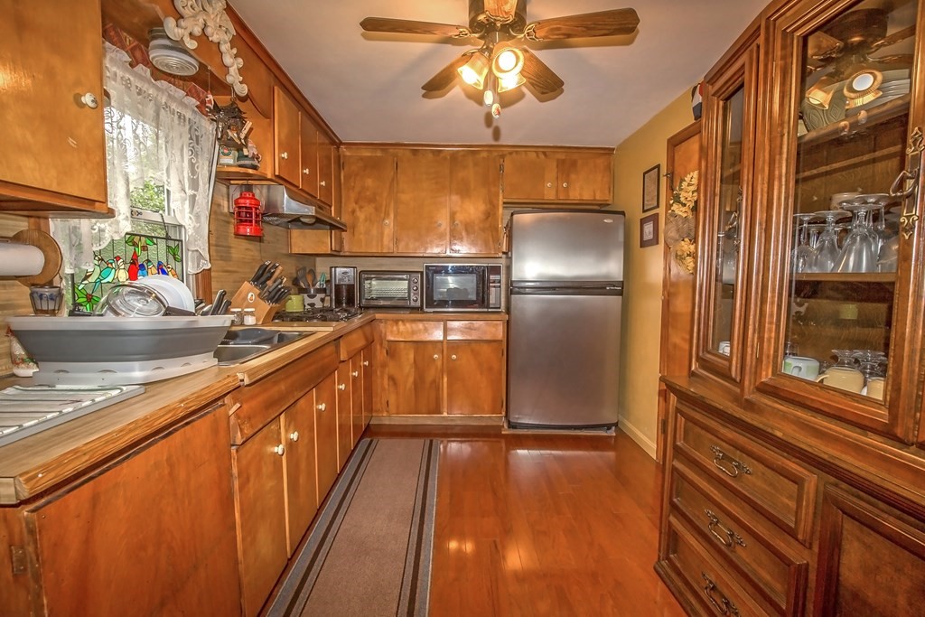 165 Bacon Road Springfield, MA 01119 - Photo 23 of 40 a kitchen with stainless steel appliances granite countertop a refrigerator a stove and a sink with wooden floors