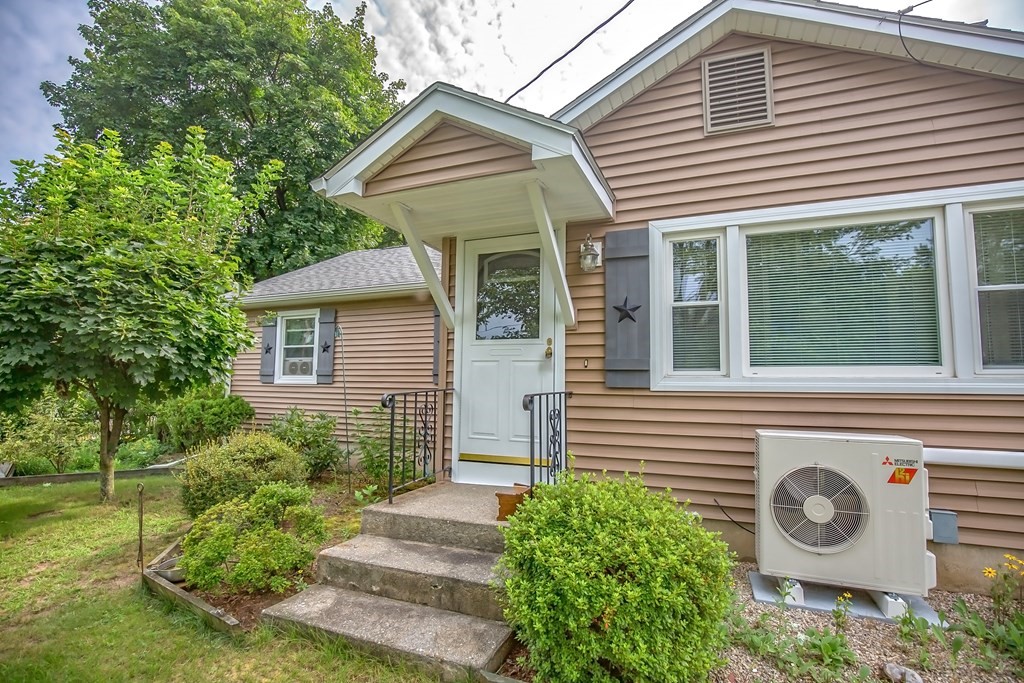 165 Bacon Road Springfield, MA 01119 - Photo 3 of 40 a view of a house with a small yard and plants