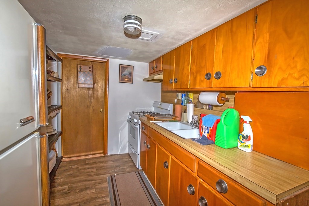 165 Bacon Road Springfield, MA 01119 - Photo 34 of 40 a kitchen with stainless steel appliances granite countertop a refrigerator and a stove
