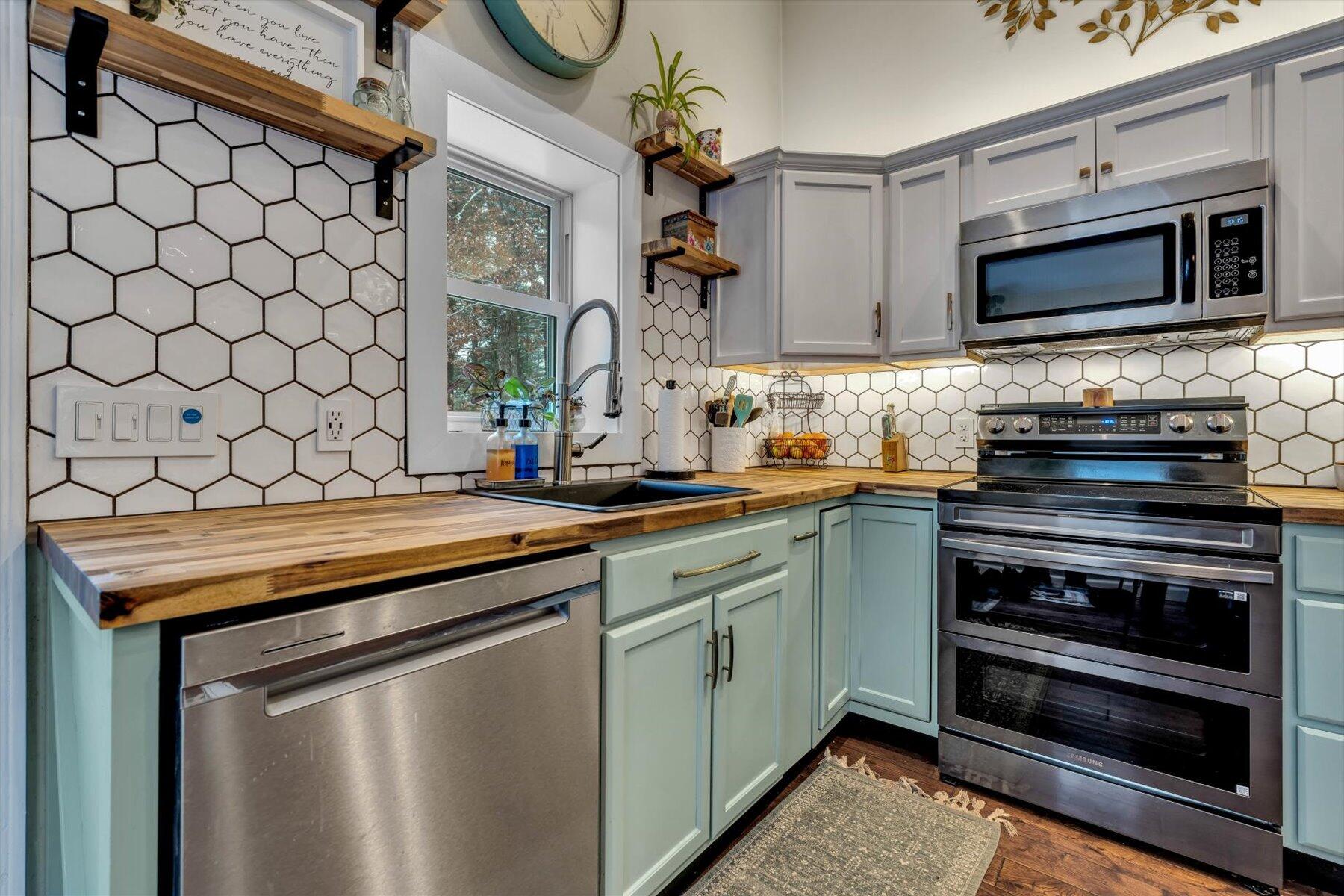 7 Summer Street Wareham, MA 02571 - Photo 4 of 41 a kitchen with stainless steel appliances a stove a microwave and sink