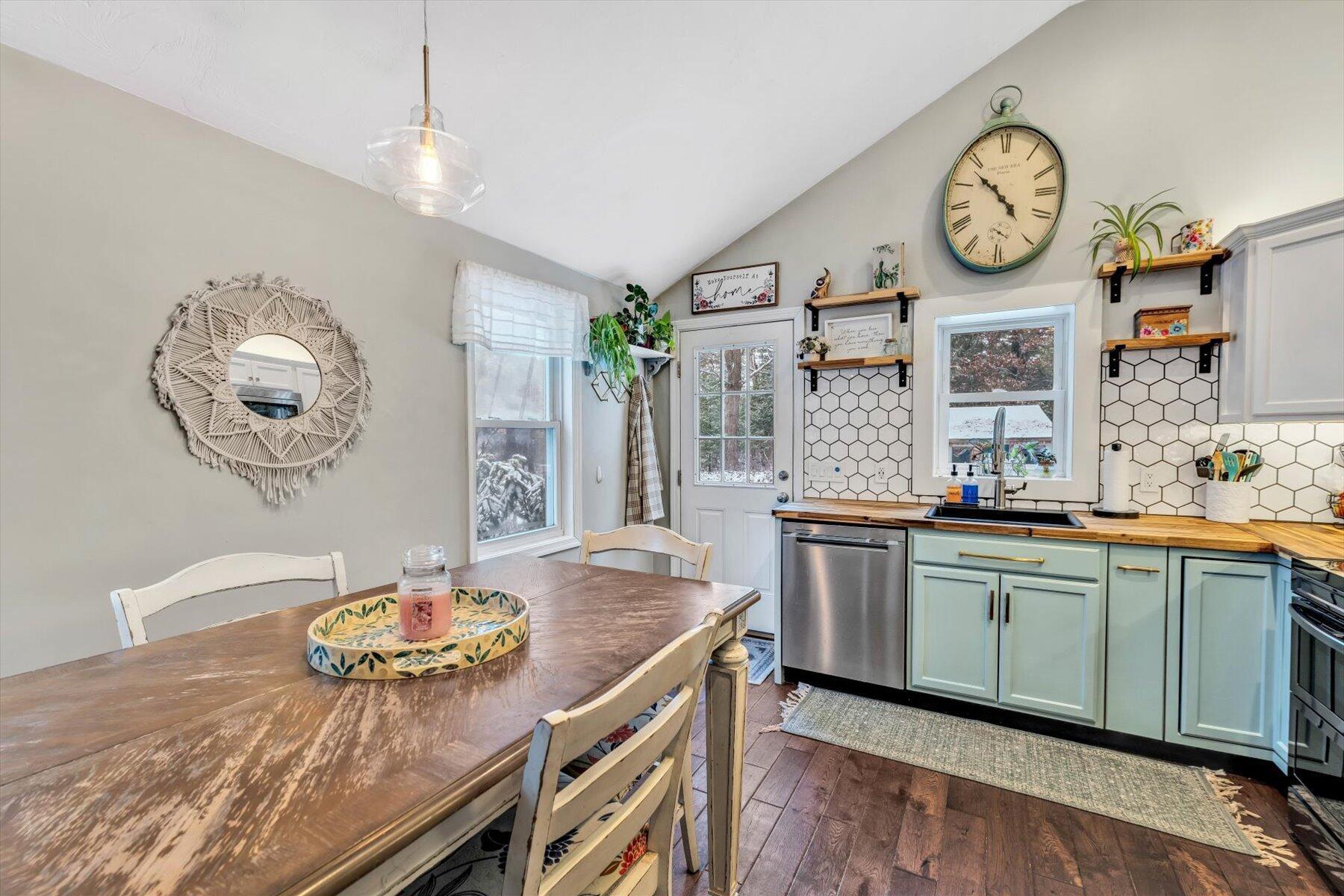 7 Summer Street Wareham, MA 02571 - Photo 5 of 41 a kitchen with a table and a clock on the wall