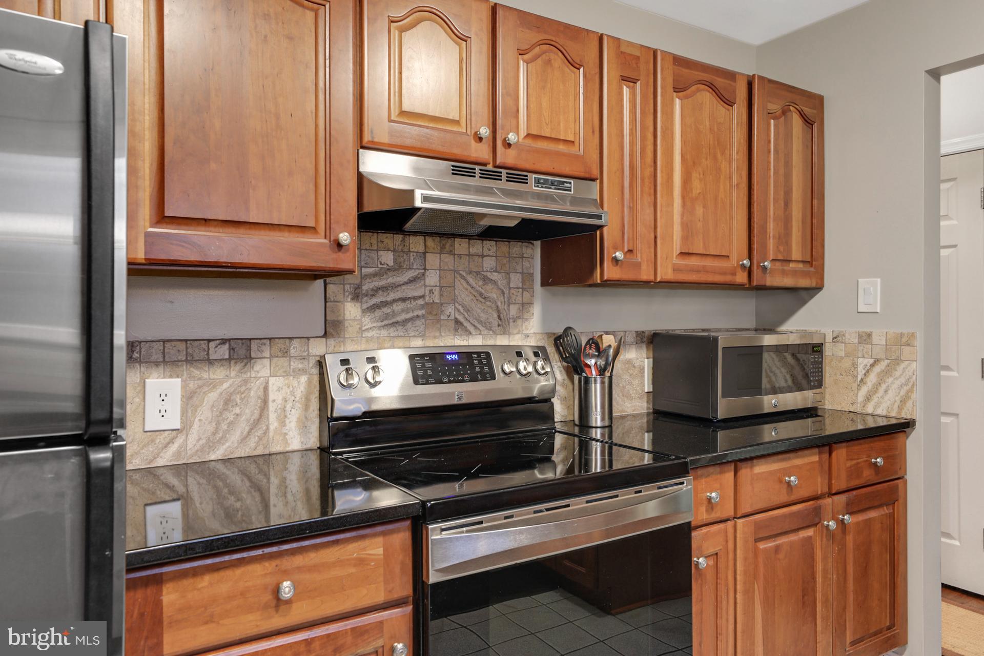 3008 Findley Road Kensington, MD 20895 - Photo 10 of 33 Stainless steel appliances and tile backsplash
