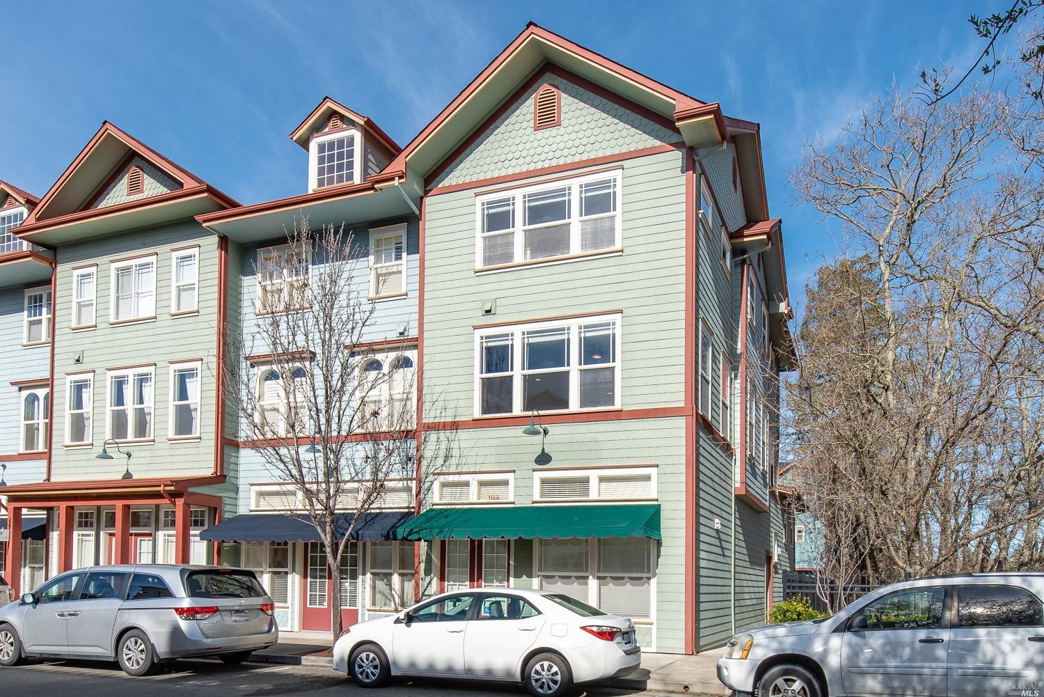 a front view of a residential apartment building with a yard