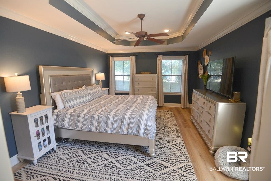 11201 Herschel Loop Daphne, AL 36526 - Photo 21 of 32 Bedroom featuring ceiling fan, crown molding, a raised ceiling, and light wood-type flooring