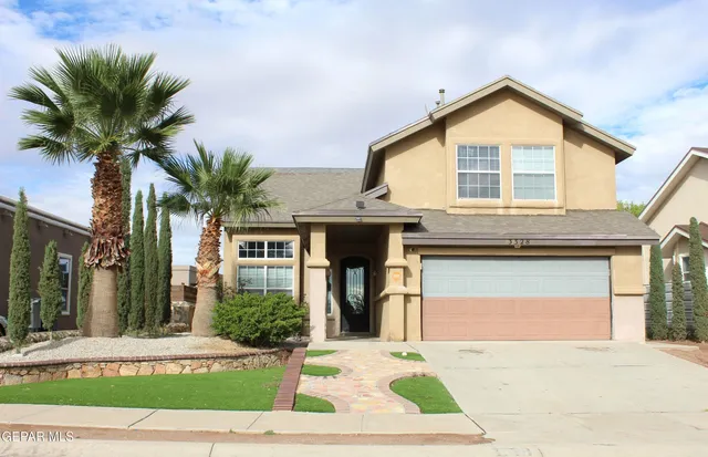 a front view of a house with a yard and garage
