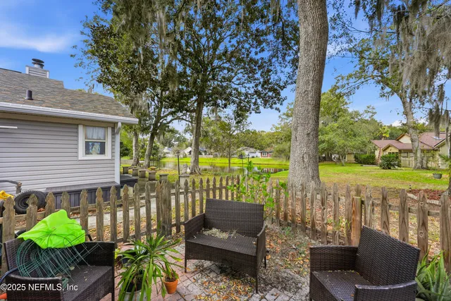 a view of a patio with couches table and chairs and potted plants