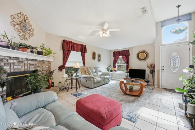 a living room with furniture a fireplace and decor