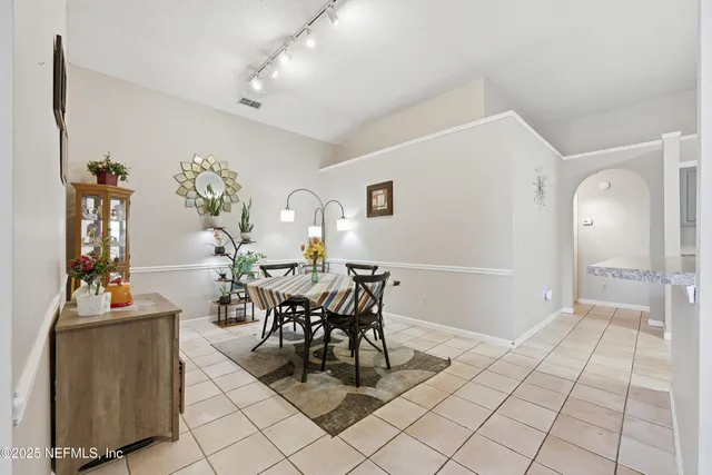 a view of a dining room with furniture and chandelier