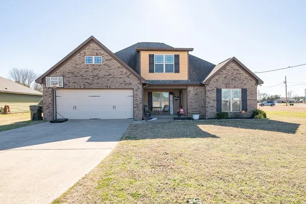 a front view of a house with a yard and garage