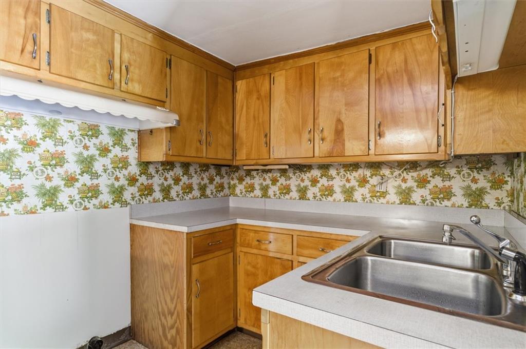 870 Marietta Road Canton, GA 30114 - Photo 26 of 43 a kitchen with granite countertop white cabinets and sink