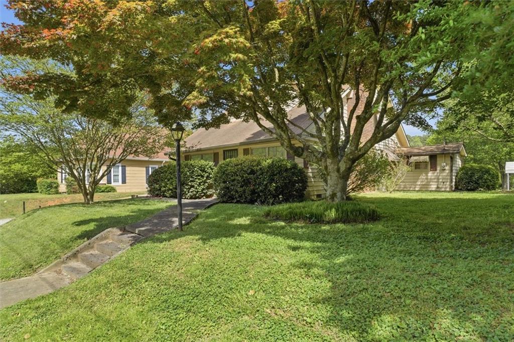 870 Marietta Road Canton, GA 30114 - Photo 3 of 43 a garden with trees in front of it