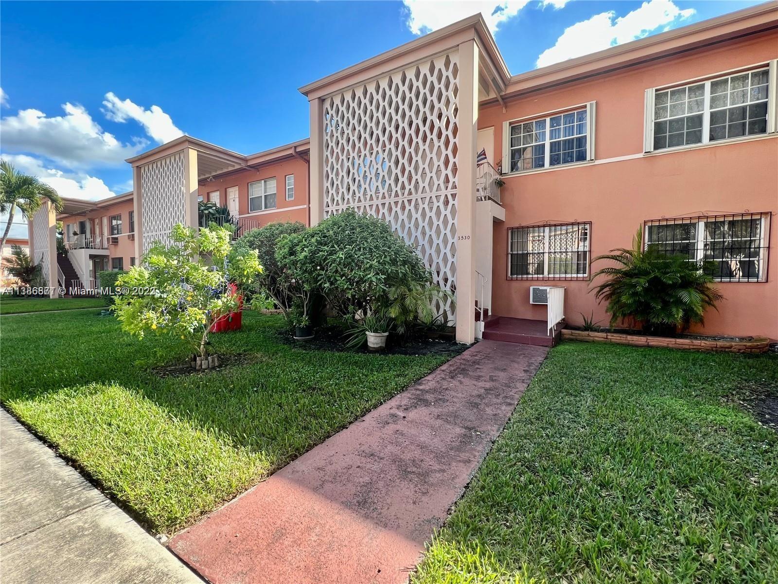 3530 Southwest 10th Street, Unit 2 Miami, FL 33135 - Photo 1 of 13 a view of a garden with a pathway